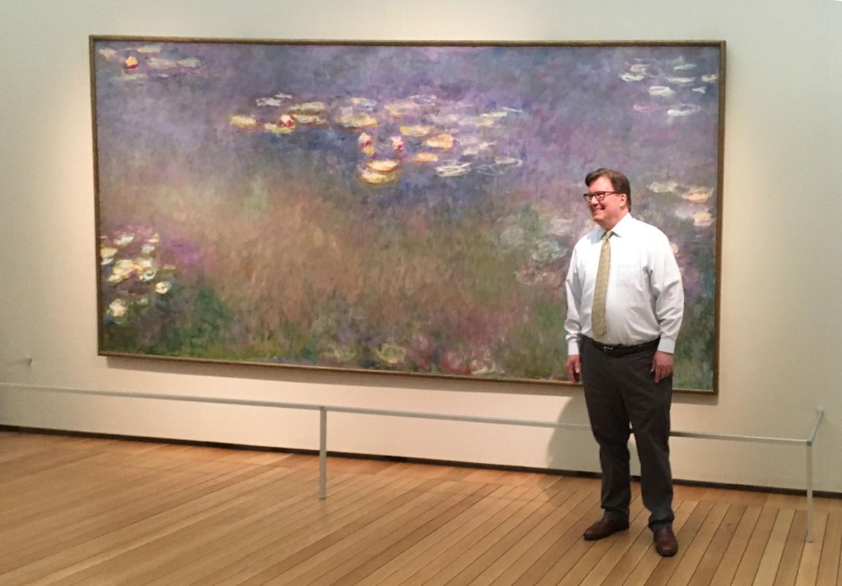 Man in front of Monet painting