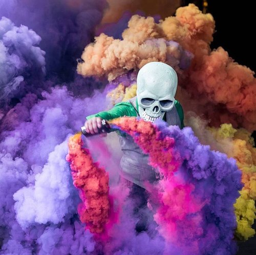 skull figure and colored smoke image