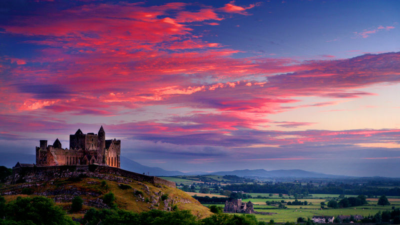 castle in the distance and a sunset in the background